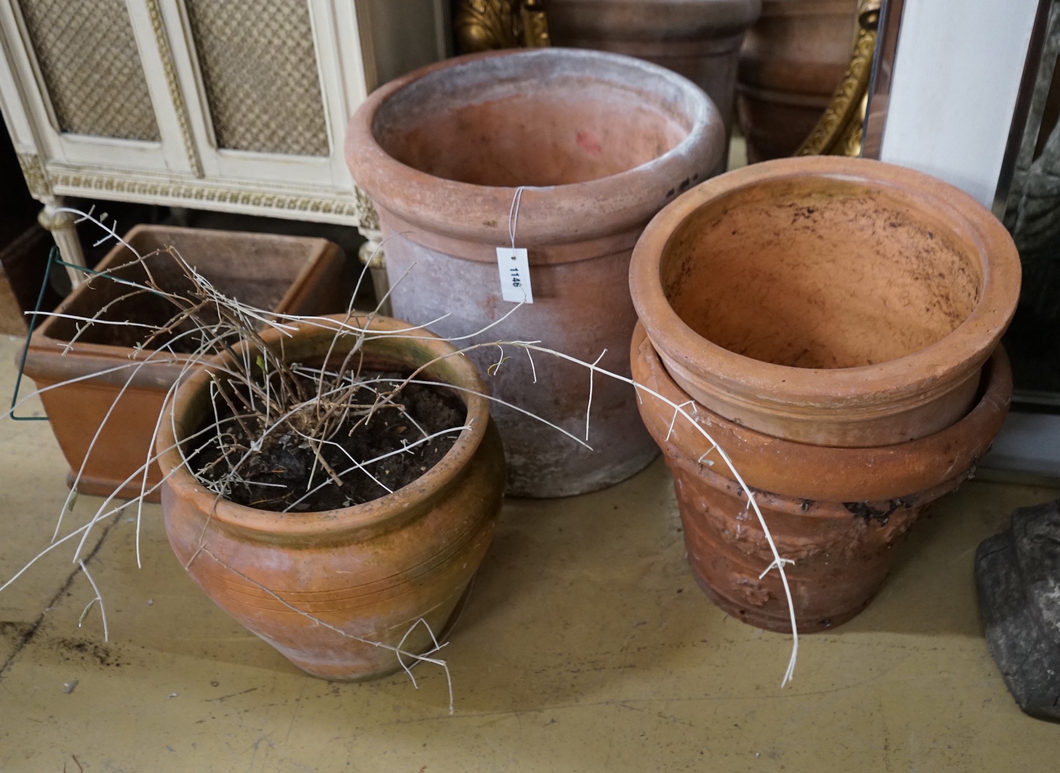 Four circular terracotta garden planters, together with a square planter, largest diameter 48cm, height 48cm